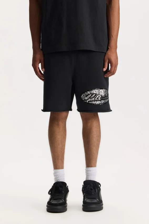 Pantalones cortos con letras de lentejuelas